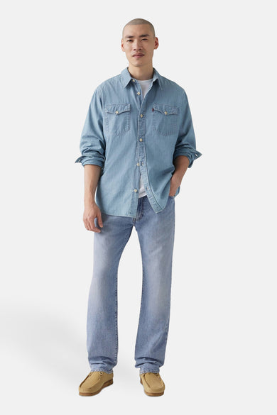 Straight jeans in lichtblauw denim van Levi's, gedragen met een lichtblauw overhemd en suède schoenen.
