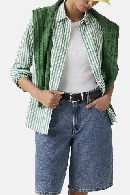 Blauwe denim shorts van Levi's met mid-rise pasvorm, gedragen met gestreept overhemd en groene vest, lifestyle shot.