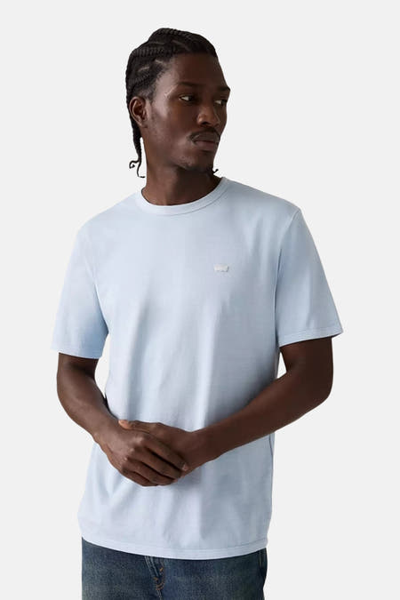 Blauw T-shirt met korte mouwen van Levi's, gedragen met een donkere jeans, tegen een witte achtergrond.