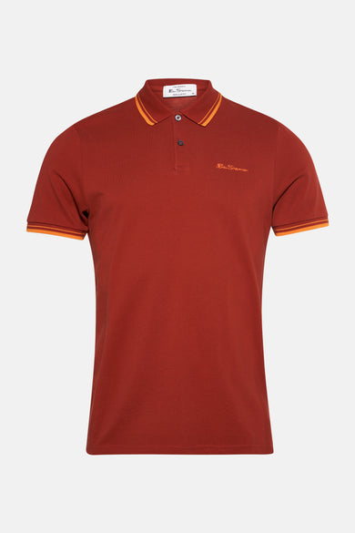 Polo orange à manches courtes de Ben Sherman, avec un logo brodé sur la poitrine et des détails rayés.