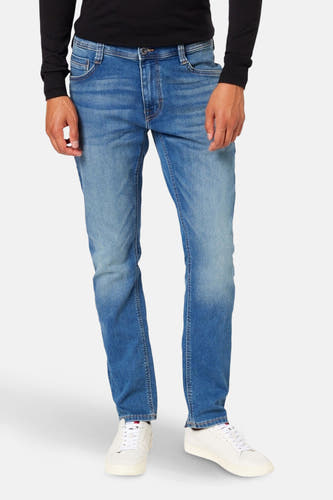 Blauwe slim-fit jeans van MUSTANG, gecombineerd met witte sneakers en een zwarte trui.
