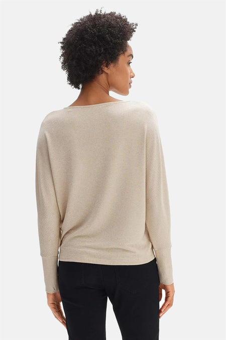 Beige pull met ronde hals van OPUS met geribbelde textuur, wijde mouwen, op model van achteren gezien met zwarte broek.