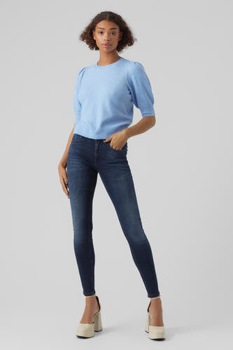 Pullover bleu avec col rond de VERO MODA, porté avec un jean foncé et des chaussures à talons de couleur crème.