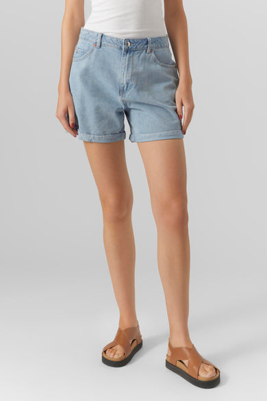 Lichtblauwe denim short van VERO MODA, met opgerolde pijpen en een casual uitstraling, gecombineerd met leren sandalen.
