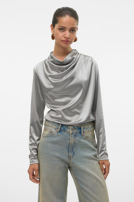 Grijze blouse met lange mouwen van VERO MODA, met een gedrapeerde halslijn en gecombineerd met jeans.
