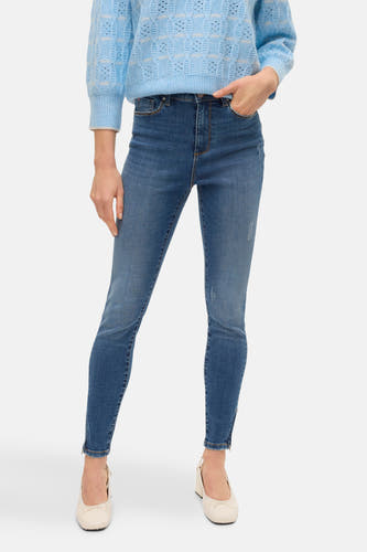 Blauwe trui met ronde hals van VERO MODA®, gedragen met een spijkerbroek en pumps.