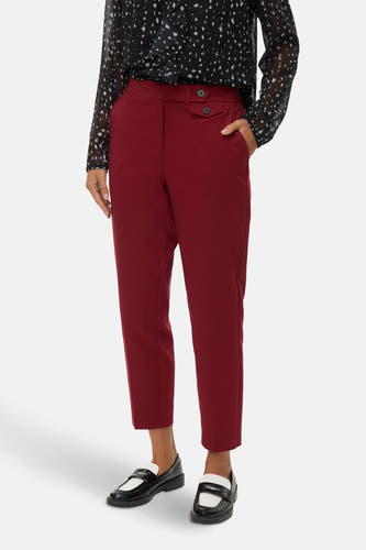 Rode broek van VERO MODA®, met knoopdetail en steekzakken, gecombineerd met een zwart-witte blouse en loafers.
