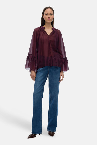 Bordeaux blouse met lange mouwen van VERO MODA, met wijde mouwen en gecombineerd met jeans en laarzen.