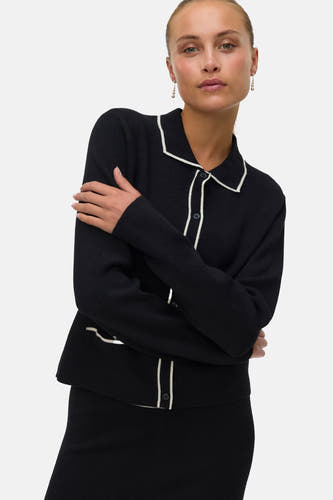 Gilet noir de VERO MODA, vu de l'arrière avec une bordure blanche au col.