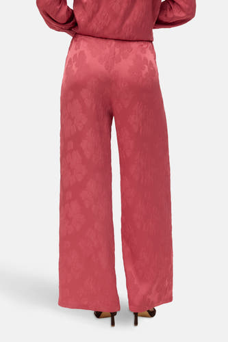 Roze broek van VERO MODA®, met bloempatroon en wijde pijpen, gezien van achteren.
