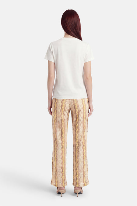 Multicolor broek van VERO MODA® met beige, bruin en geel golvend patroon, wijde pijpen, rugaanzicht.