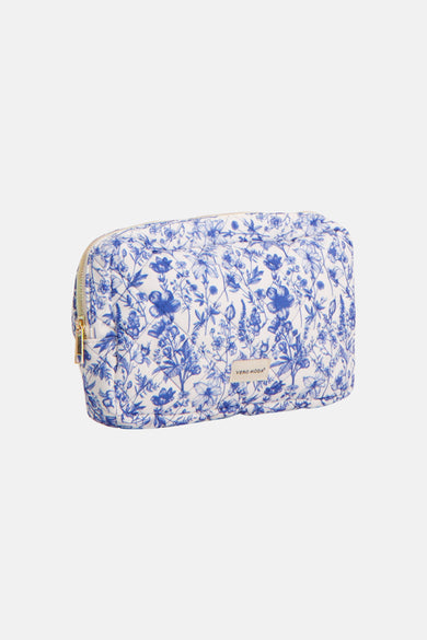 Blauwe toilettas van VERO MODA, met een bloemmotief en een gouden ritssluiting.