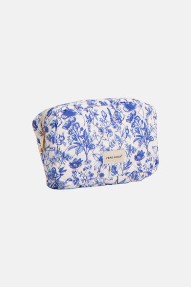 Blauwe toilettas van VERO MODA met een wit florale print en goudkleurige ritssluiting.