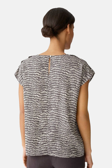 Blouse brune à manches courtes d'OPUS, avec un motif à points et un détail de nœud sur le dos.