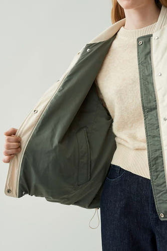 Mauve court manteau d'OPUS, avec une doublure verte et une poche intérieure.