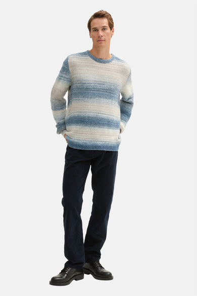 Blauwe trui met ronde hals van TOM TAILOR, met een gestreept dessin, gecombineerd met donkerblauwe corduroy broek en zwarte schoenen.
