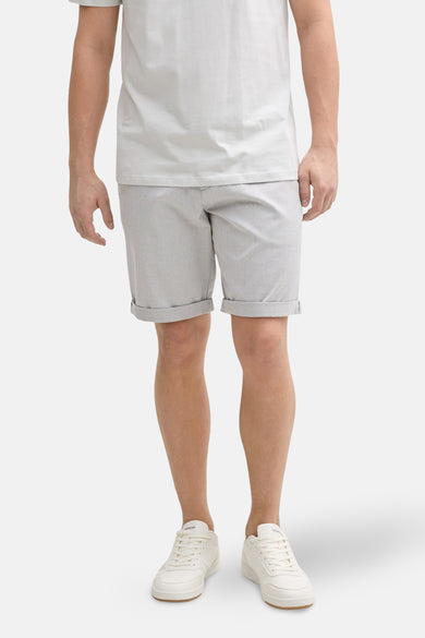 Grijze short van TOM TAILOR met omslag, gecombineerd met een wit T-shirt en witte sneakers.