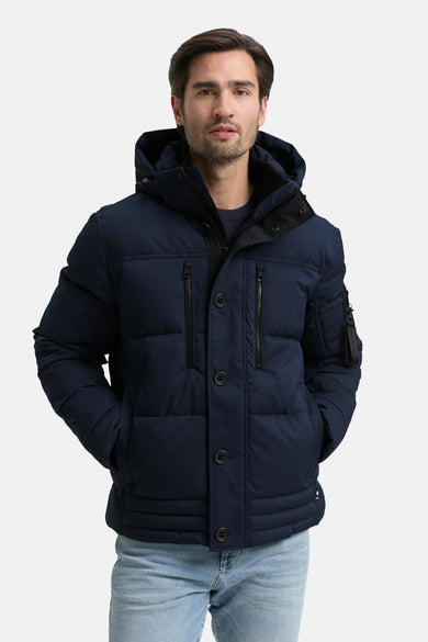 Manteau court bleu de TOM TAILOR, avec capuche et poches, associé à un jean bleu clair.