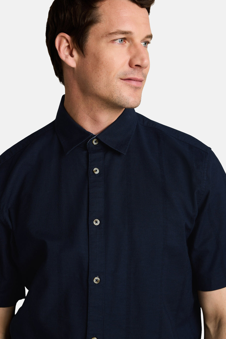 Donkerblauw korte mouwen overhemd van TOM TAILOR met fijne textuur en witte knopen, close-up van model in profiel