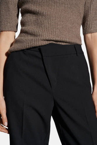 Pantalon noir d'OPUS, avec une taille haute et une texture lisse.