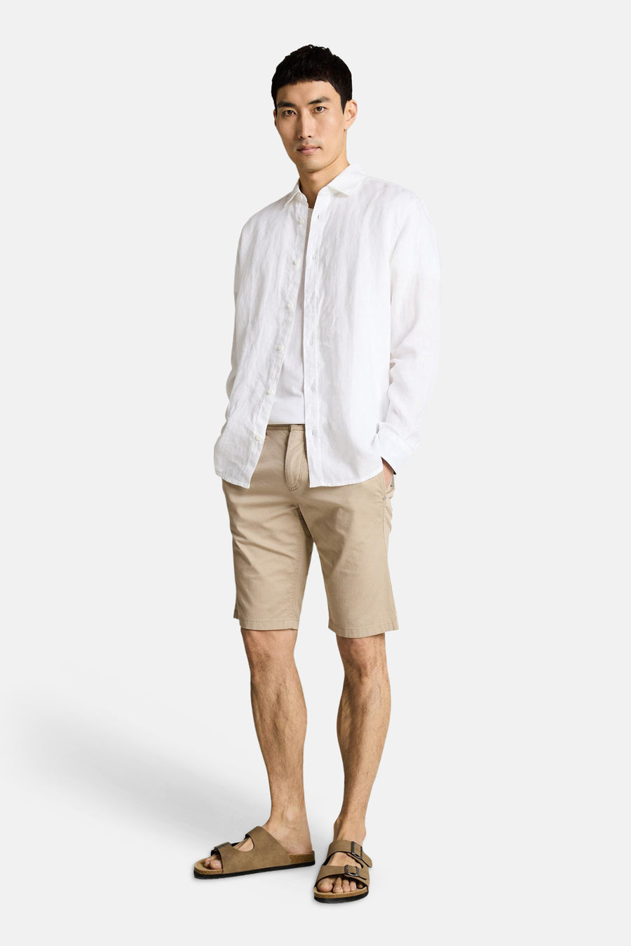Beige bermuda van TOM TAILOR, gedragen met een wit T-shirt, een wit linnen overhemd en bruine sandalen.
