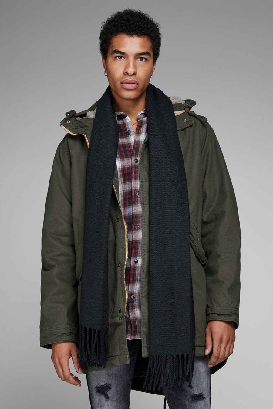 Zwarte wintersjaal van ACCESSORIES BY JACK & JONES, met franjes gedragen bij een groene parka en geruit overhemd.
