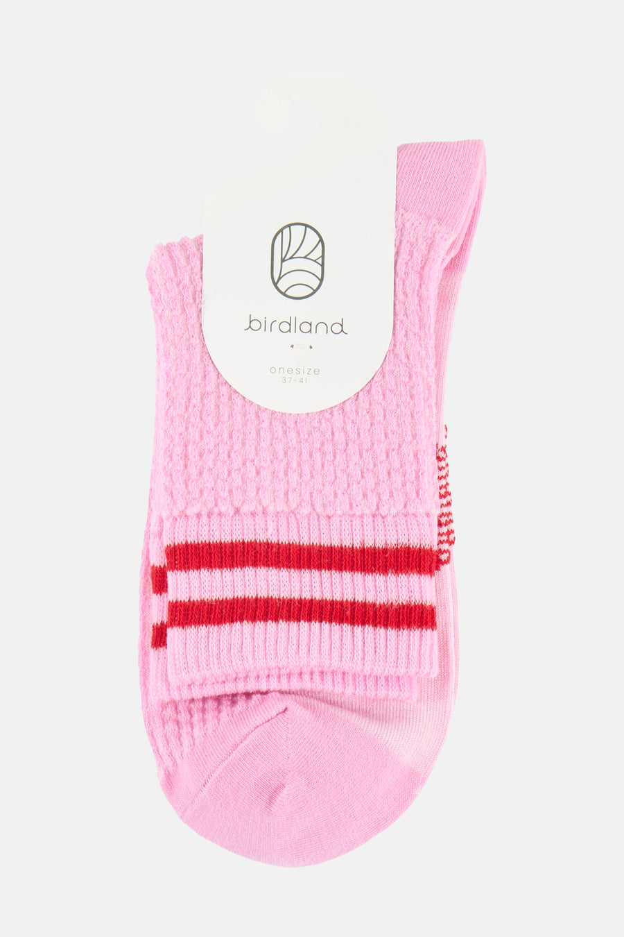 Roze sokken van BIRDLAND met een gebreide textuur, twee rode strepen en wit label.