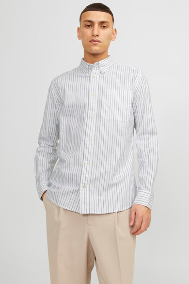 Chemise bleue rayée de PREMIUM par JACK & JONES, à manches longues, avec poche poitrine et pantalon beige.