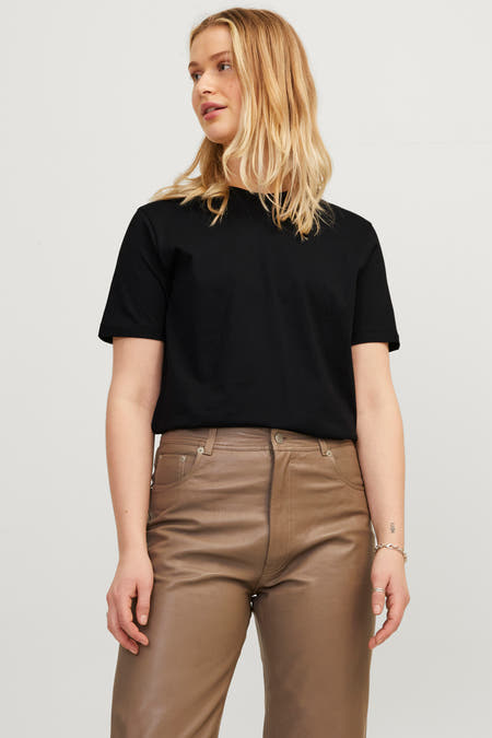 Zwart T-shirt van JJXX, gedragen met bruine leren broek en een zilveren armband.
