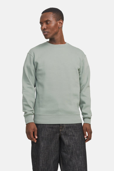 Pull-over vert vert avec col rond de CORE BY JACK & JONES, porté avec des jeans foncés.
