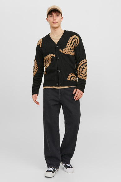 Jean large gris foncé de JACK & JONES JEANS INTELLIGENCE, porté avec un cardigan noir en maille orné de motifs dorés et une casquette beige, vue de face.