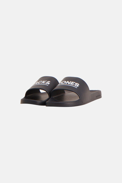 Tongs noir JACK & JONES, avec logo blanc 'LES' sur la bride et 'JACK & JONES' sur la semelle, en vue latérale.