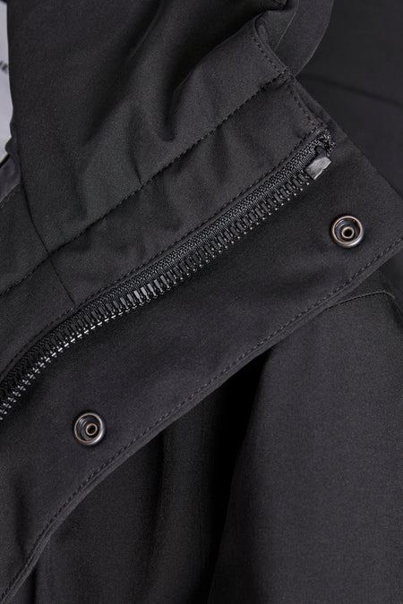Lange zwarte jas van CORE BY JACK & JONES, met zilverkleurige ritssluiting en drukknopen.