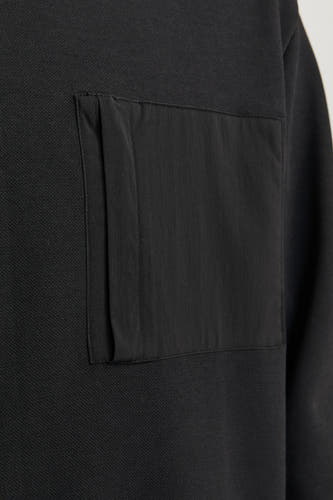 Zwarte sweater van CORE BY JACK & JONES, met een rechthoekige zak op de borst.