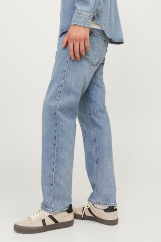 Jean tapered bleu clair de JACK & JONES JEANS INTELLIGENCE, avec texture stonewash, associé à des chaussures en cuir beige.