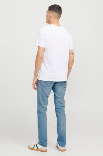 Lichtblauwe slim fit jeans van JACK & JONES JEANS INTELLIGENCE, met lichte wassing en witte sneakers.
