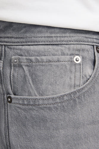 Jean wide délavé clair de JACK & JONES JEANS INTELLIGENCE, avec une coupe classique à cinq poches et des détails métalliques argentés.