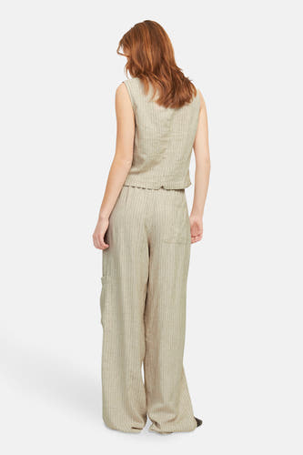 Beige mouwloze blouse van JJXX, met een fijn streepjespatroon, gedragen met bijpassende gestreepte broek.
