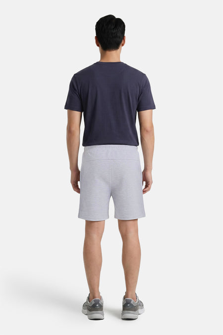 Grijze katoenen shorts van JACK & JONES JEANS INTELLIGENCE, achterkant, met donkerblauw T-shirt en grijze sneakers
