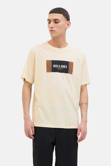 T-shirt jaune à manches courtes de CORE by JACK & JONES, avec un logo rectangulaire sur la poitrine, porté avec un pantalon noir.