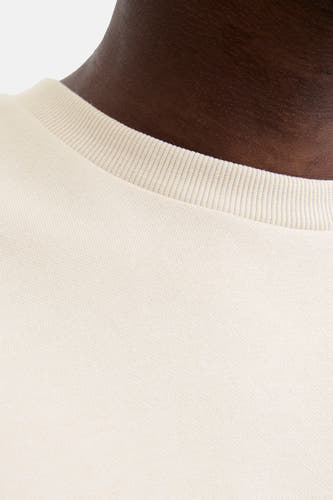 Gilet beige de CORE BY JACK & JONES, avec col rond côtelé et détails texturés.