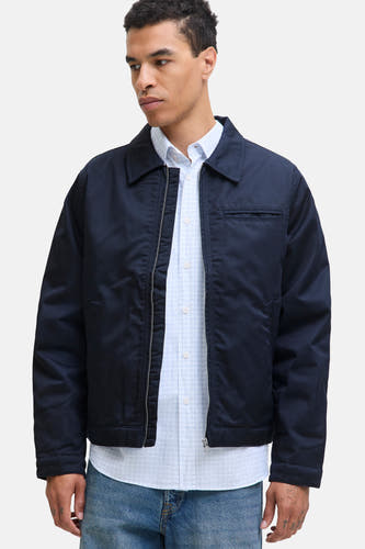 Blauwe korte jas van ORIGINALS BY JACK & JONES, met rits en een lichtblauw overhemd eronder, gecombineerd met jeans.
