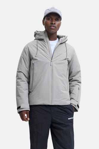 Grijze korte jas van CORE BY JACK & JONES, met capuchon en zwarte broek.
