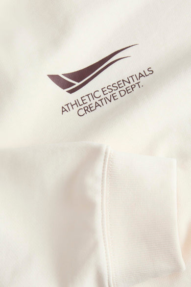 Gilet beige de CORE BY JACK & JONES, avec un logo graphique et un bord côtelé.