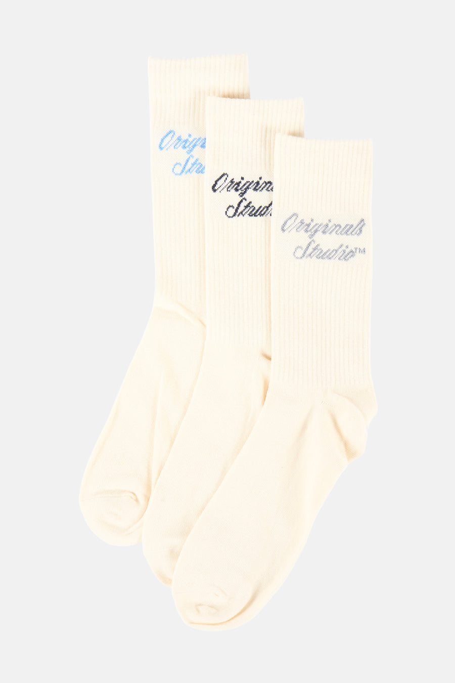 Chaussettes beige d'ACCESSORIES BY JACK & JONES avec du texte bleu marine 'Originals Studio', emballées dans du carton.