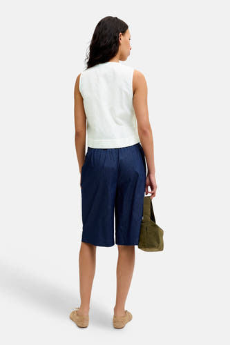 Witte mouwloze blouse van JJXX met fijne textuur, van achteren gezien, gedragen met donkerblauwe shorts.