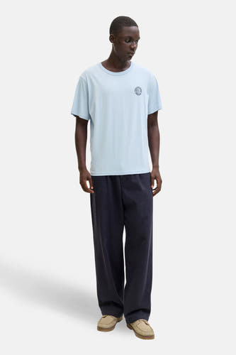 Blauw T-shirt met korte mouwen van ORIGINALS BY JACK & JONES, met logo op de borst, gedragen met donkere broek en beige schoenen.