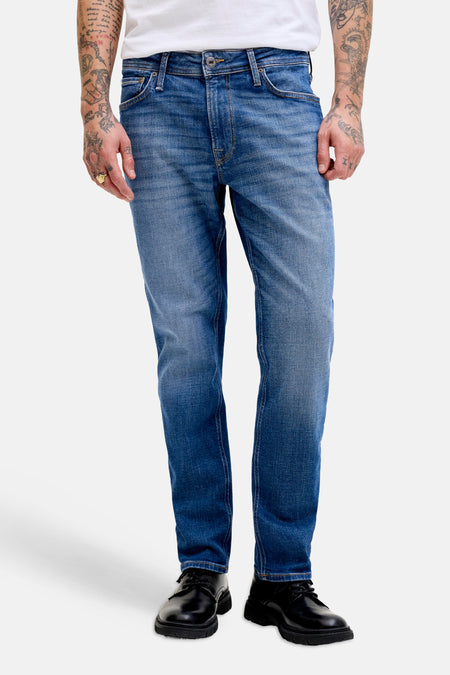 Rechte jeans van middenblauw denim van JACK & JONES JEANS INTELLIGENCE, gedragen door een man met een wit T-shirt en zwarte schoenen.