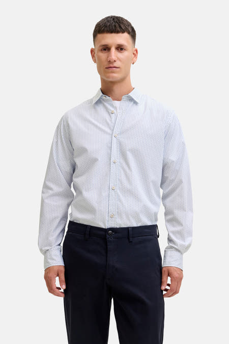 Wit overhemd met lange mouwen van PREMIUM by JACK & JONES, met een subtiel stippenpatroon en donkere pantalon.
