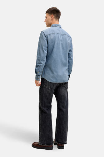 Jeanshemd van lichtblauw denim van ORIGINALS BY JACK & JONES, met lange mouwen, gedragen met donkergrijze jeans en bruine schoenen.